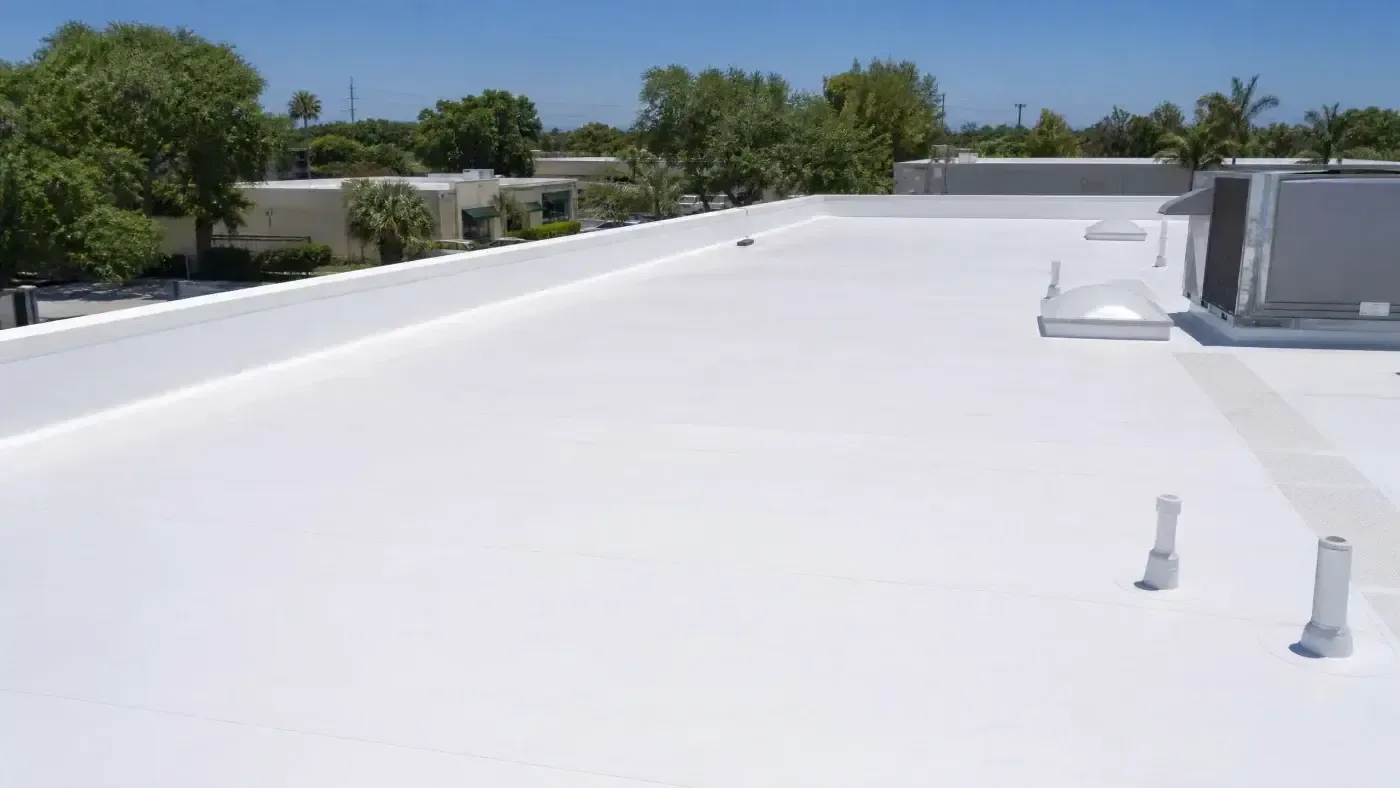 White low-slope commercial roof after maintenance